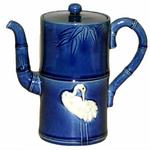 Antique Japanese Awaji Pottery Teapot with Applied Cranes
** Circa 1900
** In segmented bamboo form with applied white cranes set against a deep blue ground.  Impressed plover mark.
** H: 6 1/2, W: 6
** $2,800